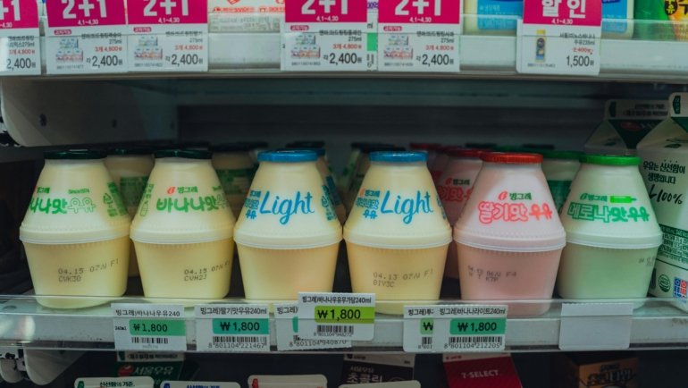 Open travel trailer fridge (RV fridge) interior, showcasing fresh food and cold drinks for enjoyable camping and travel.