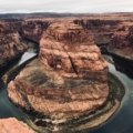 Breathtaking panoramic view of the Grand Canyon's vast, colorful landscape under a clear sky, representing ideal conditions for a visit during spring or fall.