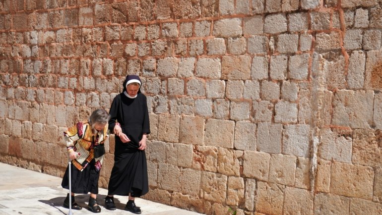ER travel nurse confidently planning her next assignment on a tablet, symbolizing the rewarding career, flexibility, and adventure of high-paying travel nursing jobs.
