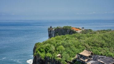 Exotic Travelers login portal displayed on a laptop, with a vibrant exotic beach in the background, representing secure and easy access to member travel benefits and exclusive vacation management.