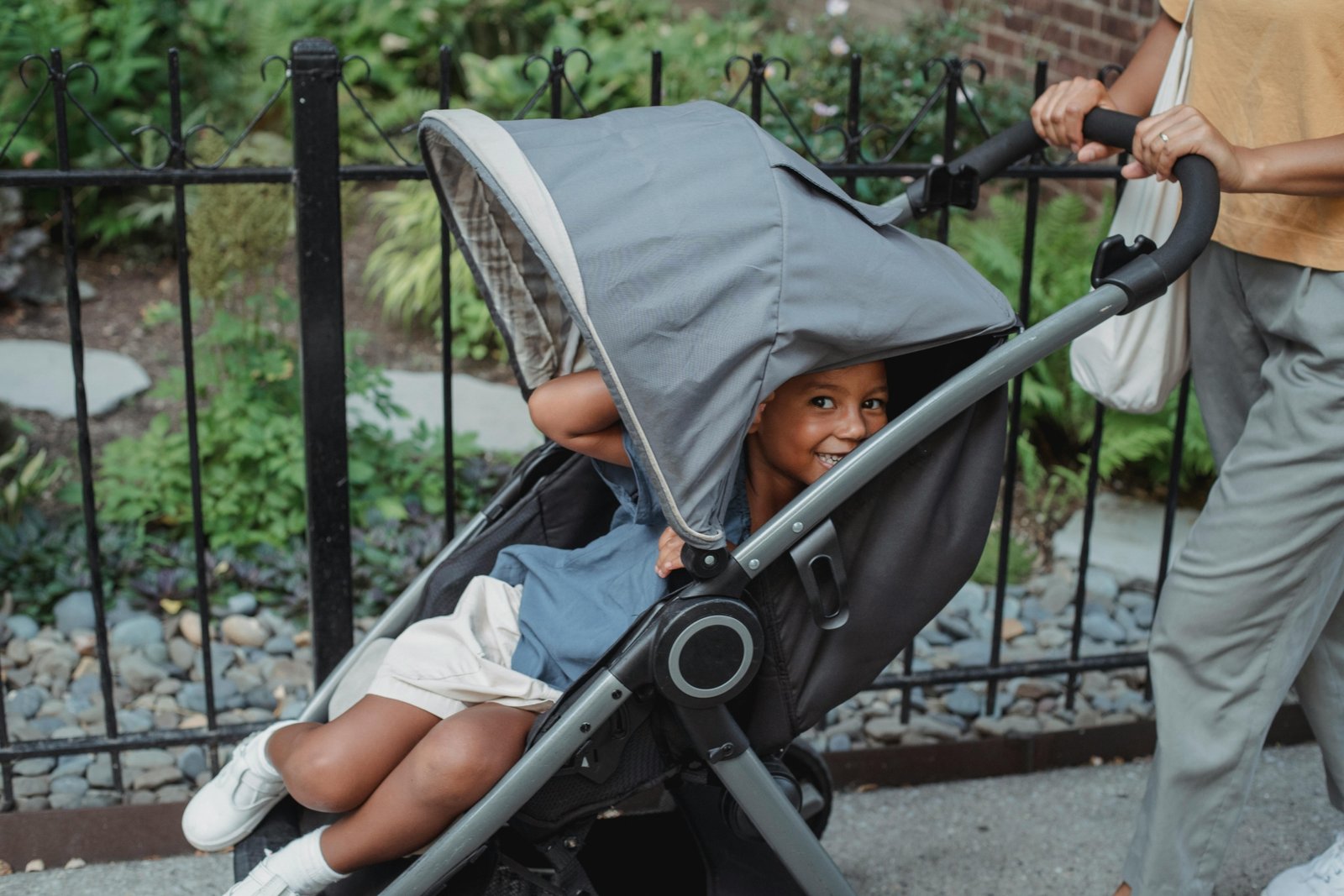 Happy family traveling with a lightweight, compact stroller at an airport, showcasing the convenience and ease of modern travel with children.