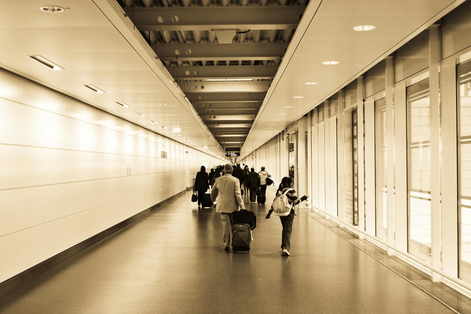 Parents with a baby easily navigating an airport terminal with a lightweight, compact travel stroller, highlighting stress-free family plane travel.