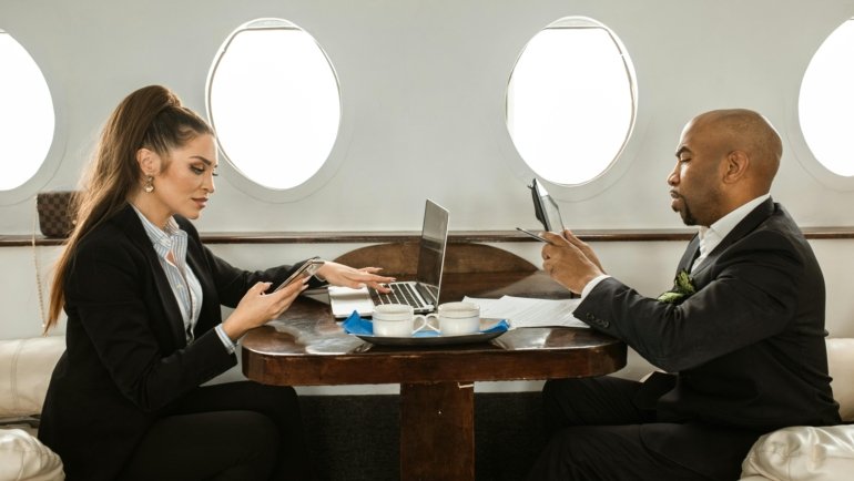 Professional diverse business travelers efficiently managing global corporate trips with digital tools, illustrating strategic B2B travel and effective travel management company (TMC) solutions.