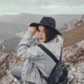 Empowered solo female traveler with a backpack exploring a vibrant destination, symbolizing freedom, self-discovery, and the 'creativeculturetribe' movement in solo female travel.
