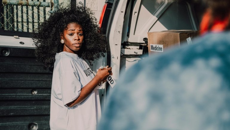 A traveling social worker providing compassionate support and case management to a diverse community in an international location, embodying global aid and resilience.