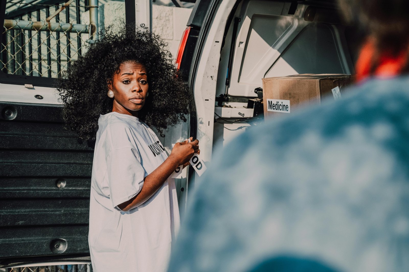 A traveling social worker providing compassionate support and case management to a diverse community in an international location, embodying global aid and resilience.