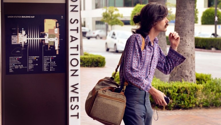 A traveler confidently navigating a bustling city street with a modern anti-theft travel bag, symbolizing secure valuables and peace of mind during their journey.