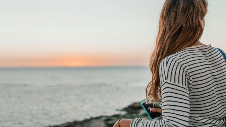 Inspiring image of a traveler enjoying a serene moment in a beautiful landscape, symbolizing a perfect February getaway with fewer crowds and unique experiences.