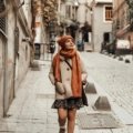 Stylish woman with anti-theft crossbody travel purse exploring a European city street, emphasizing secure and comfortable sightseeing.