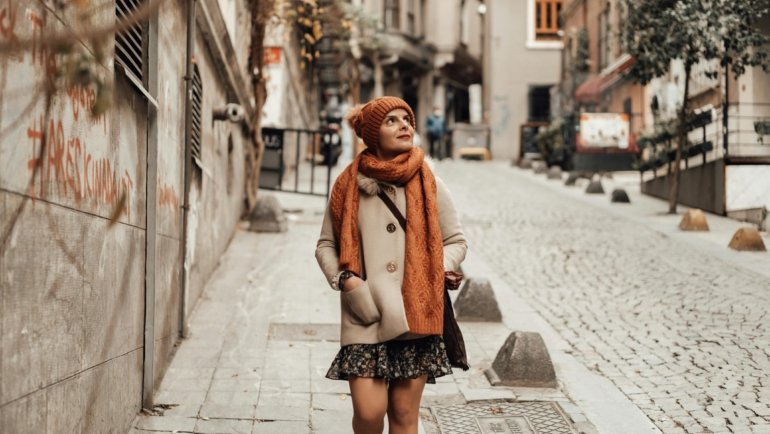 Stylish woman with anti-theft crossbody travel purse exploring a European city street, emphasizing secure and comfortable sightseeing.