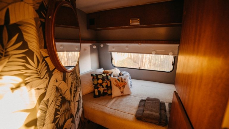 Traveler relaxing comfortably on an airplane seat, covered by a cozy travel pillow blanket, highlighting its dual function as a soft cushion and warm cover for long journeys and enhanced travel comfort.