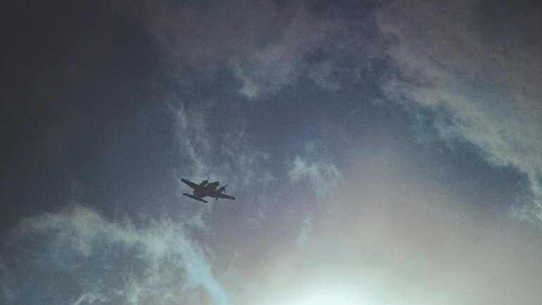 Commercial airplane cruising at high altitude above a sea of clouds, illustrating fuel efficiency and weather avoidance in the stratosphere.
