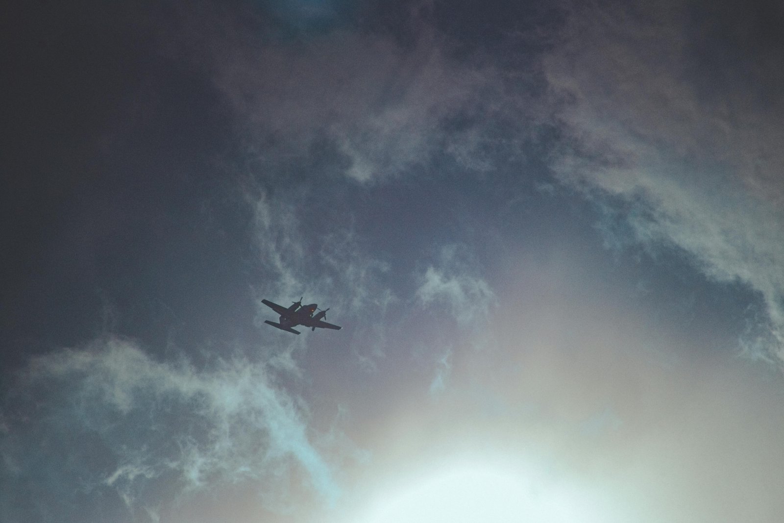 Commercial airplane cruising at high altitude above a sea of clouds, illustrating fuel efficiency and weather avoidance in the stratosphere.