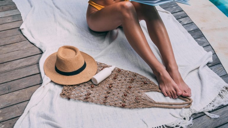 A person enjoys reading a luxury travel and leisure magazine in a beautiful, serene setting, sparking inspiration for dream getaways and unforgettable trips.