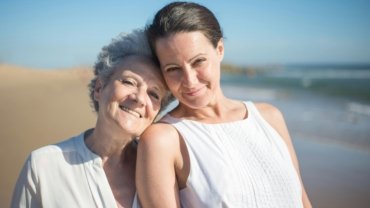 Happy mother and adult daughter enjoying a bonding travel trip, laughing together and creating unforgettable memories on their shared getaway.