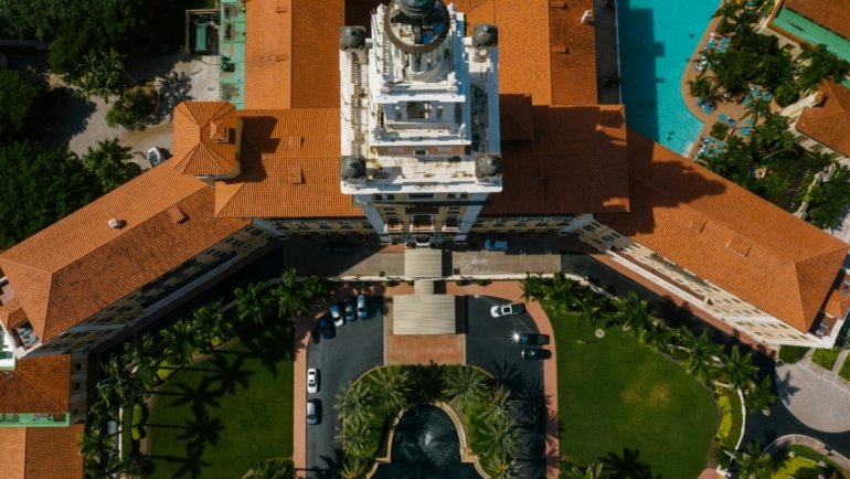 Palm Beach Traveler RV Park in Florida with modern RV sites, lush palm trees, a sparkling swimming pool, and happy travelers enjoying a sunny vacation.