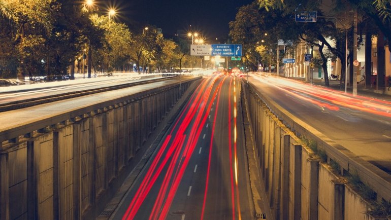 Exterior view of Donna's Travel Plaza Inc in Wadsworth, Ohio, at night, showing parked trucks, illuminated gas pumps, and the main building, highlighting it as a comprehensive rest area and truck stop for travelers.