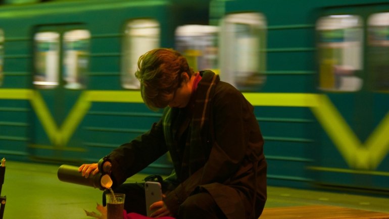 Personalized custom travel mug held by a person, ideal for daily commutes and expressing unique style with its durable, insulated design.