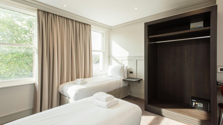 Compact travel router providing secure, fast, and reliable portable Wi-Fi connectivity for devices like laptops and smartphones in a hotel room or on the go, ensuring seamless internet access for travelers and digital nomads.