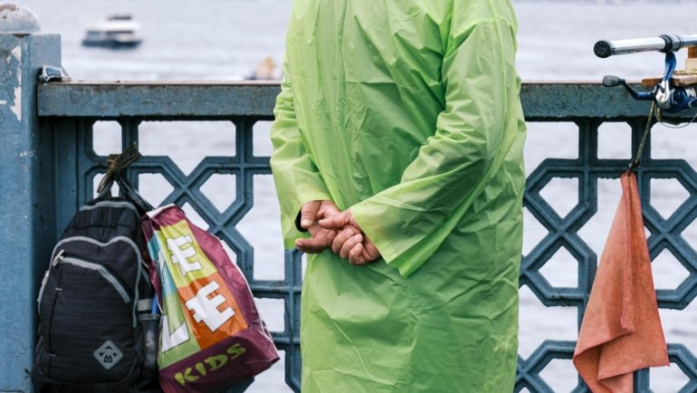 A traveler packing a lightweight, quick-drying microfiber travel towel into a backpack, highlighting efficient and compact packing for adventure travel.