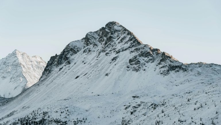 A certified travel EMT in uniform standing confidently in a breathtaking natural landscape, symbolizing exciting global career opportunities for emergency medical technicians combining medical skills with adventure and diverse experiences.