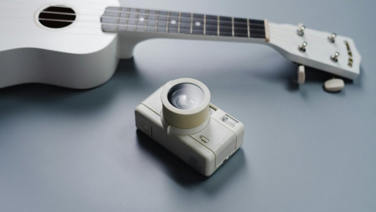 Close-up of an acoustic guitar with subtle visual effects suggesting vibration or sound waves, illustrating how technology like the Tone Traveler enhances wood for a richer, vintage tone and superior musical performance.