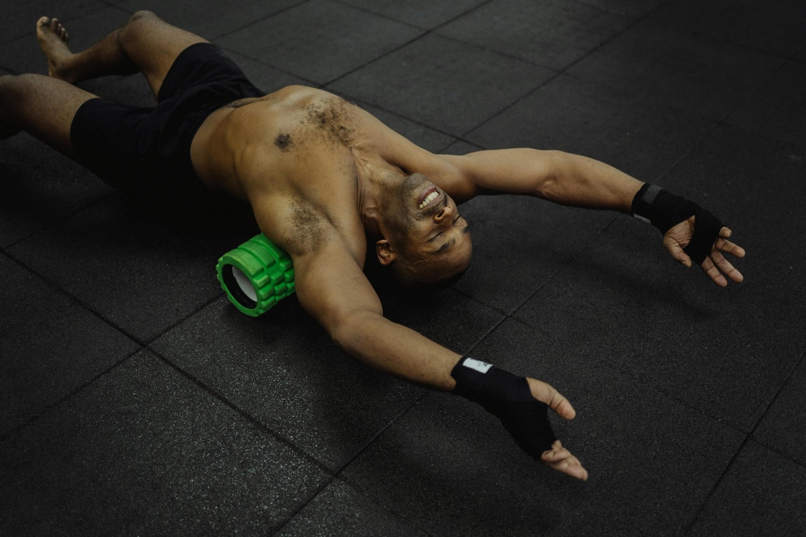 Traveler using a portable foam roller for muscle relief and recovery in a hotel room, emphasizing on-the-go wellness during trips.