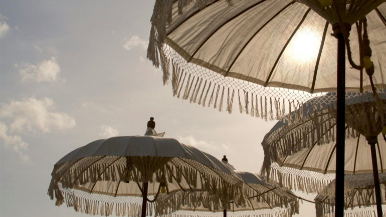 Tropical beach in Indonesia during the dry season, showcasing ideal weather for travel, with clear blue skies and calm turquoise waters, perfect for a dream vacation.