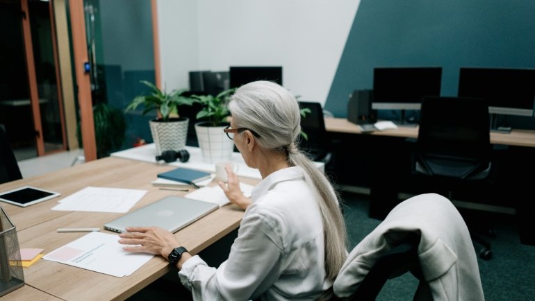 A professional travel consultant planning a customized itinerary on a laptop with a globe, illustrating modern travel agency careers and expert trip design.