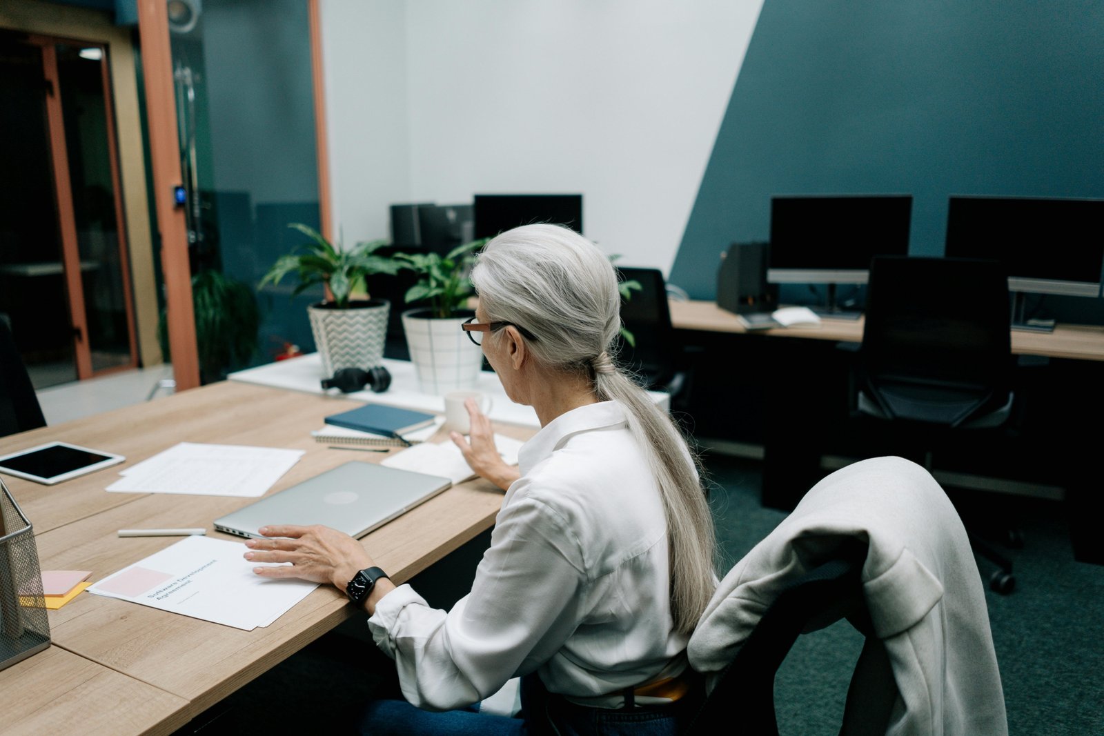 A professional travel consultant planning a customized itinerary on a laptop with a globe, illustrating modern travel agency careers and expert trip design.
