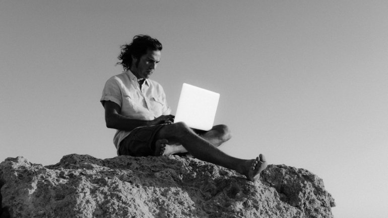 A smiling travel pharmacist standing against a scenic backdrop, embodying career adventure, professional growth, and the flexibility of working in diverse healthcare locations.