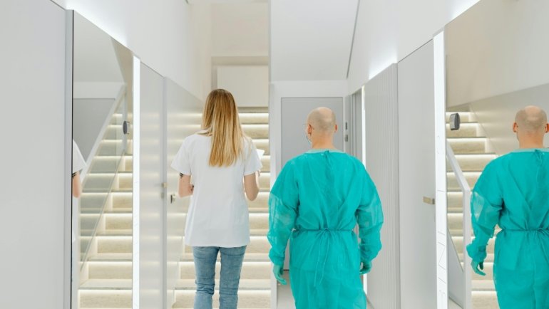 Skilled PACU travel nurse confidently in a modern hospital environment, with subtle indications of travel and exploration, signifying career growth and exciting travel nurse job opportunities.