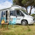 Modern Catalina travel trailer in a picturesque mountain campsite, perfect for an adventurous RV road trip and comfortable camping.