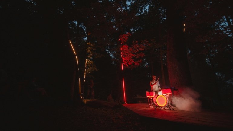 A focused drummer playing a compact travel drum kit, emphasizing portability, practice on the go, and maintaining rhythm anywhere.