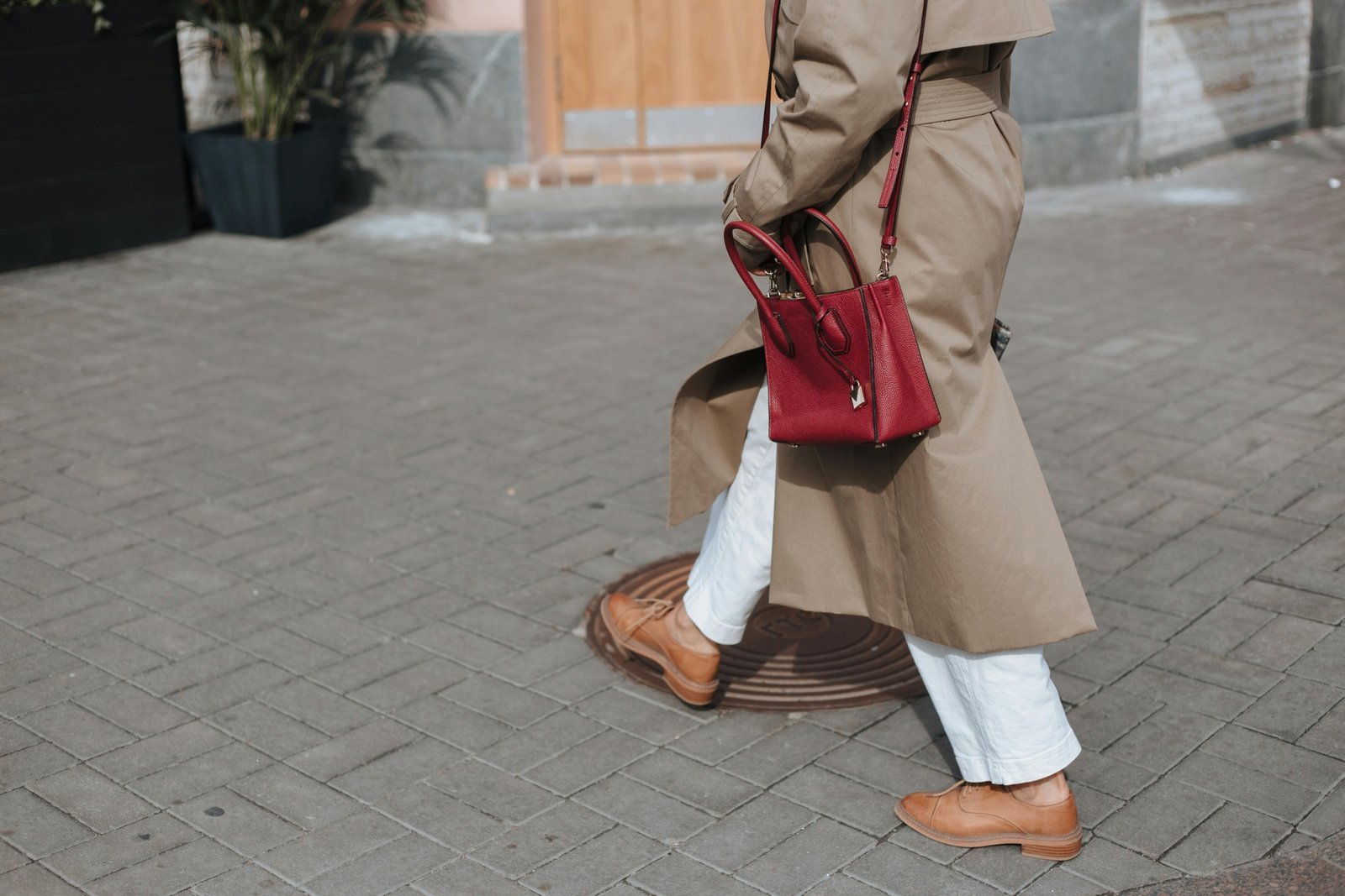 Stylish woman carrying secure travel handbag walking in European city street