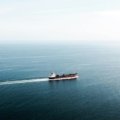 Cargo ship sailing on the open ocean during a peaceful voyage showcasing sustainable and adventurous sea travel