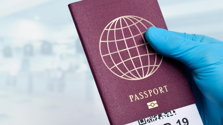 Travel hand sanitizer bottle in hand at airport showing hygiene and safety for travelers