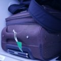 Compact travel kettle alongside packed luggage highlighting portability and convenience for travelers