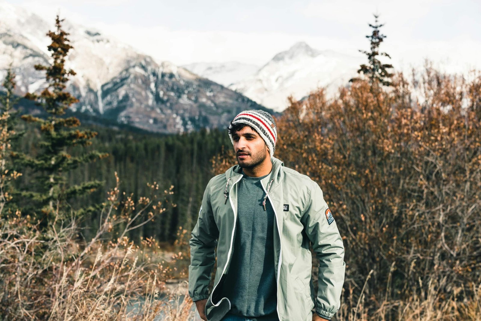 Traveler wearing a weather-resistant travel jacket outdoors in a versatile environment