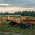 Travel trailer with mounted bike rack carrying bikes, parked in nature for outdoor adventure