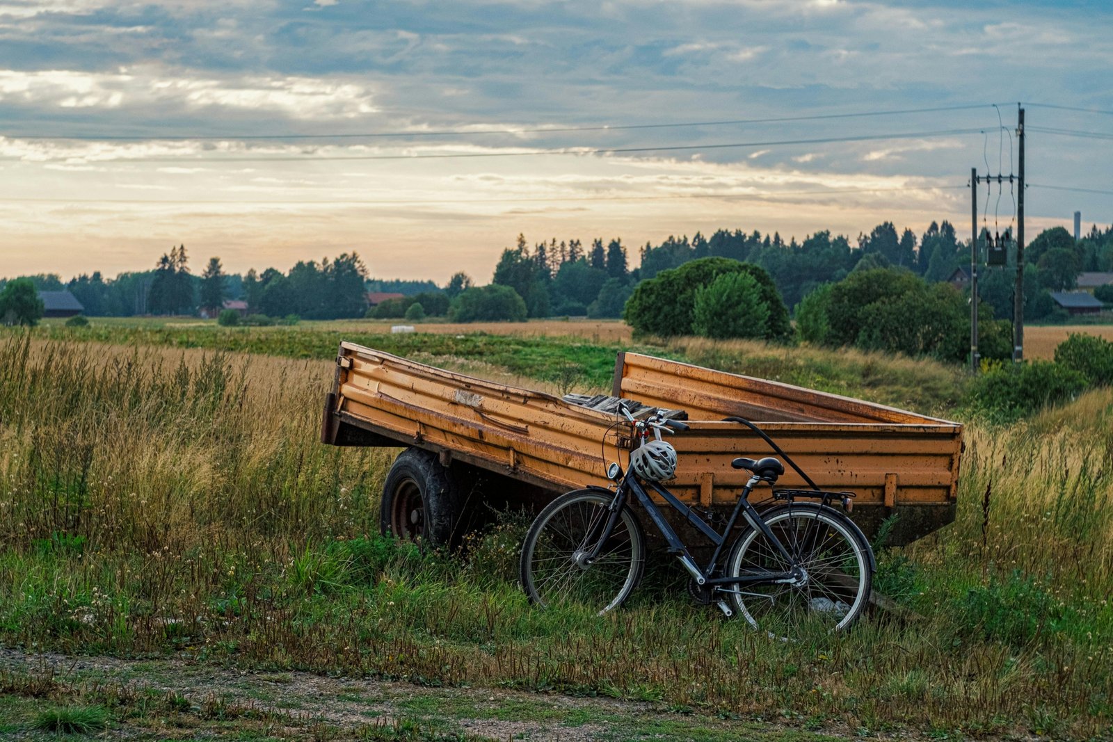 Travel trailer with mounted bike rack carrying bikes, parked in nature for outdoor adventure
