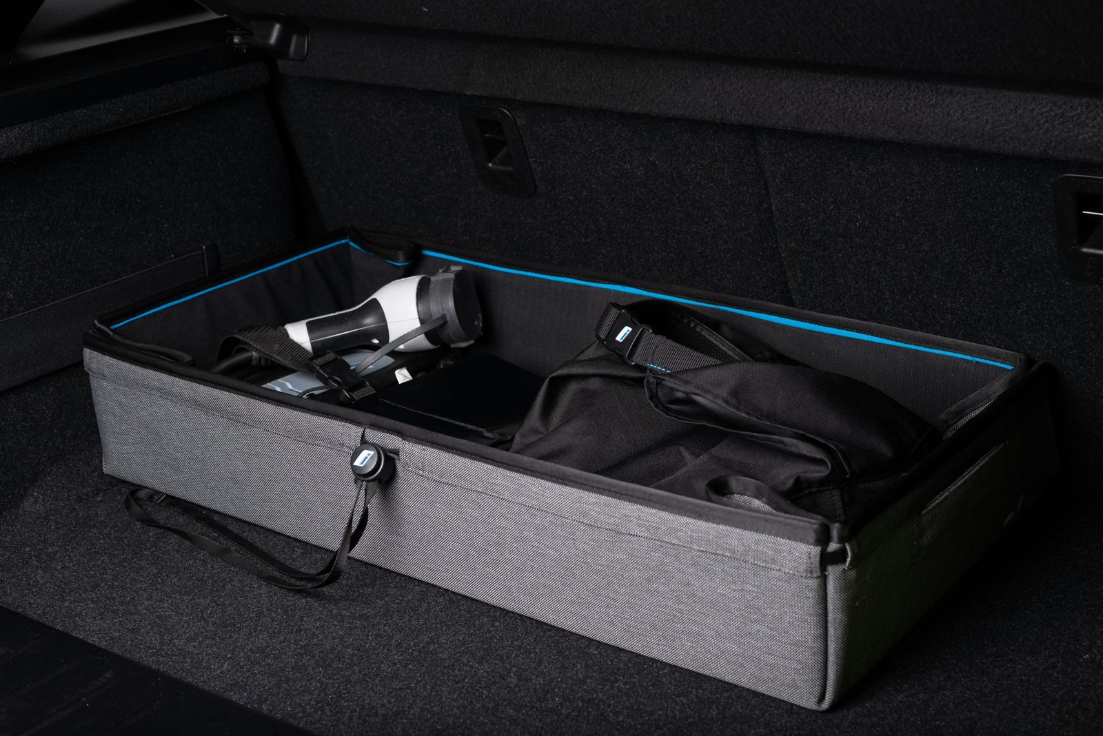 Cat using a portable travel litter box during a road trip to ensure hygiene and comfort