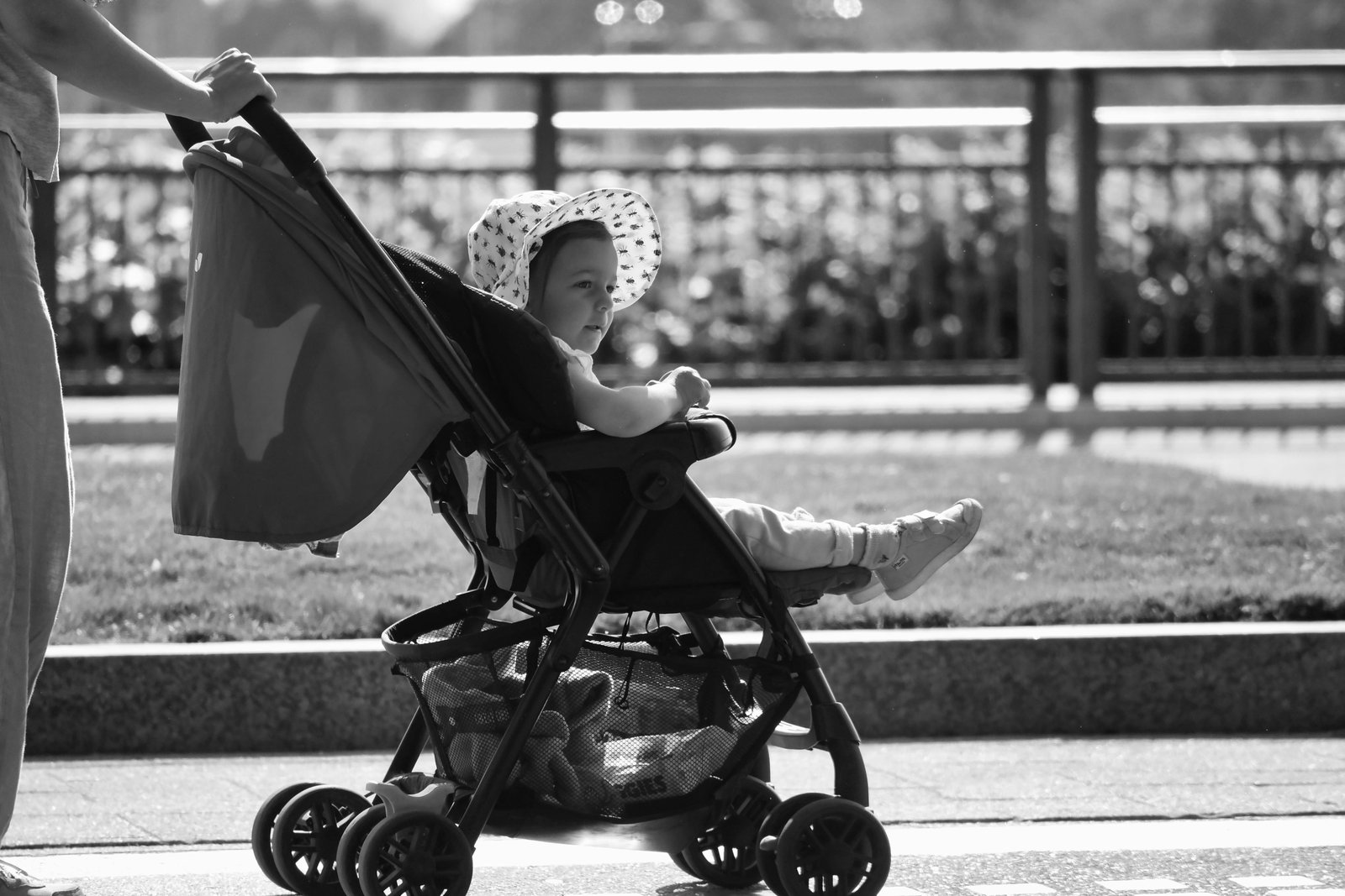 Parent traveling with lightweight stroller in city showing portable and compact baby stroller for easy travel