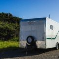 2016 bumper pull 33ft travel trailer parked in nature with clear skies and greenery