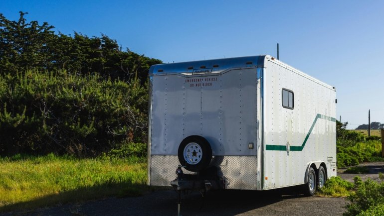 2016 bumper pull 33ft travel trailer parked in nature with clear skies and greenery