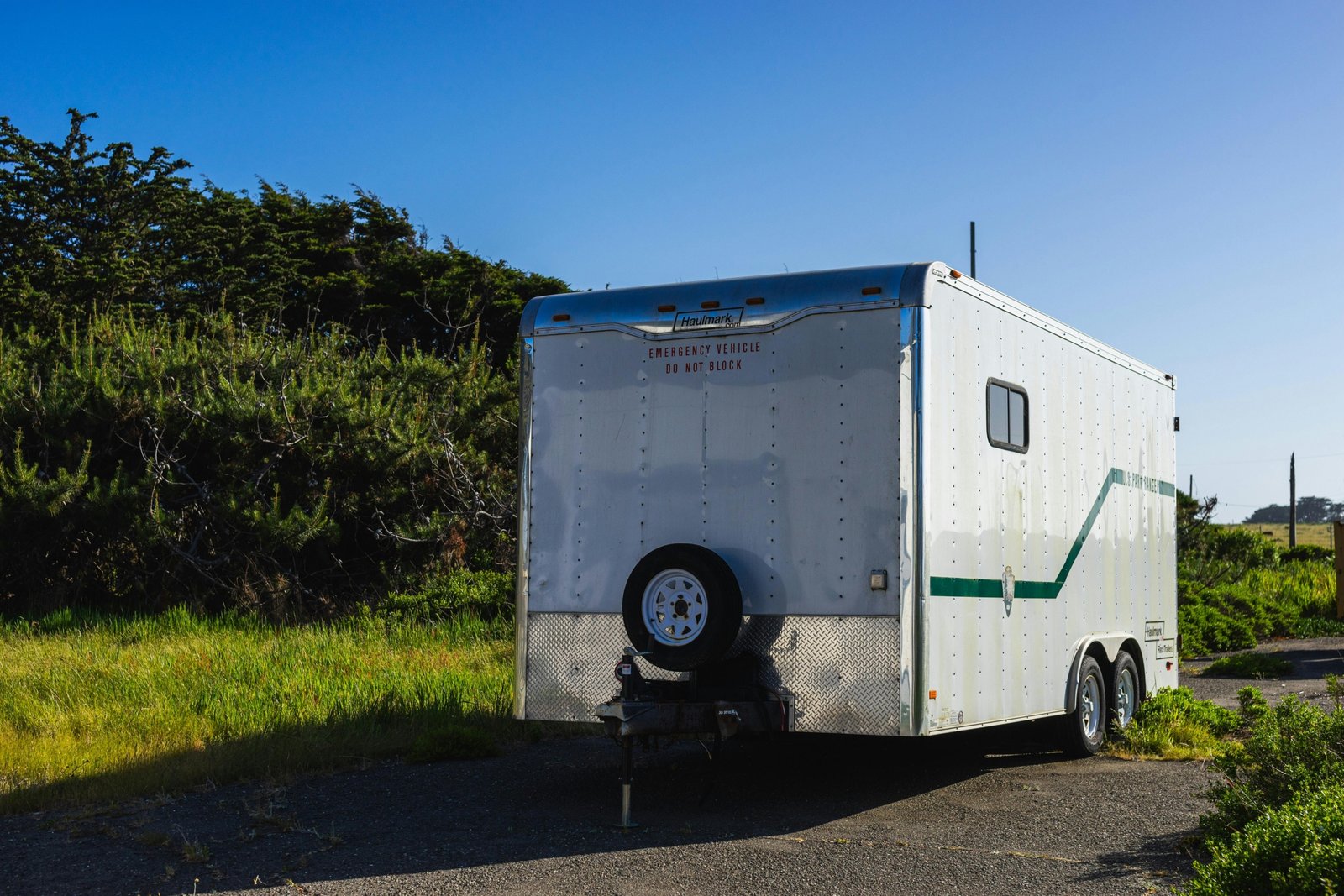 2016 bumper pull 33ft travel trailer parked in nature with clear skies and greenery