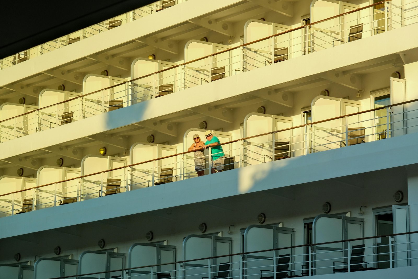 Happy couple enjoying their cruise vacation onboard, representing the ease of booking with expert cruise travel agents
