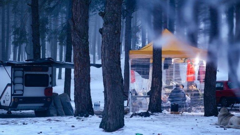 Travel trailer with winter skirting installed protecting undercarriage from cold and snow