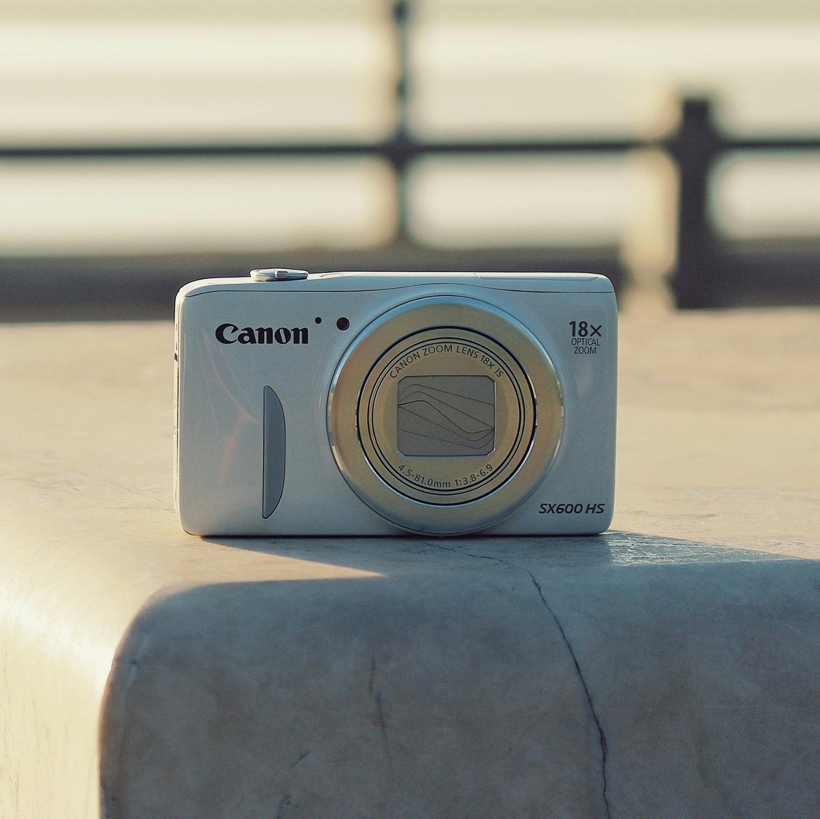 Traveler using a compact digital camera outdoors to capture high-quality travel photos