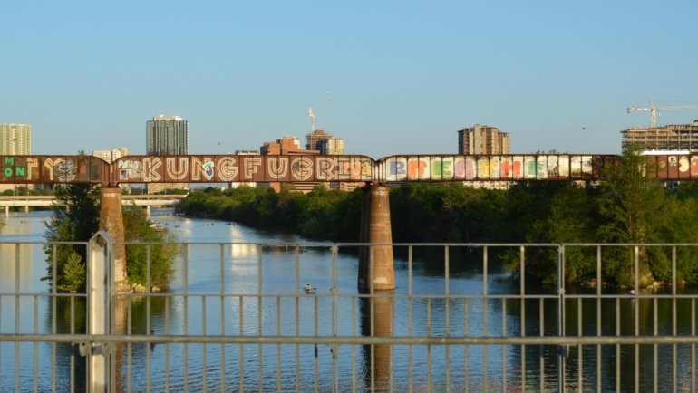 Springtime outdoor festival in Austin with blooming flowers, live music, and crowds enjoying mild weather